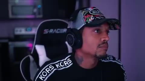 On the mic with headphones in the studio